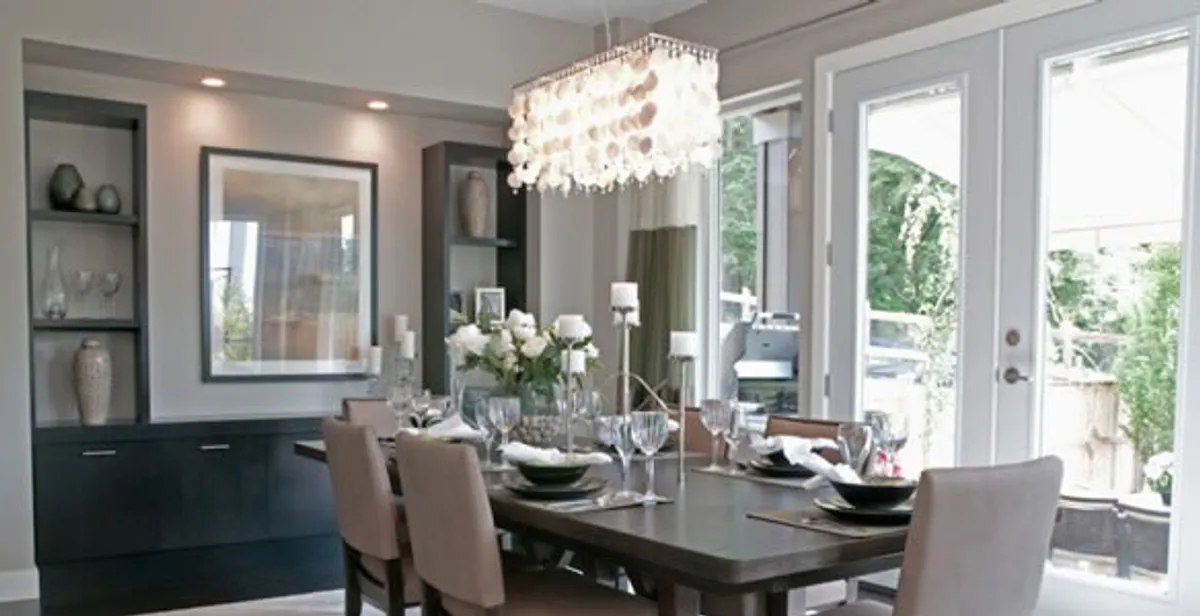 Elegant dining room chandelier installation above table in San Francisco, CA
