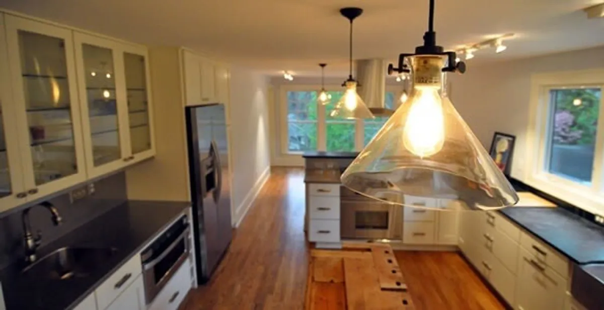 Residential electrician installing modern indoor light fixture in a home in San Francisco, CA